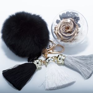 GOLD PRESERVED ROSE | BLACK FLUFFY BALL WITH FADED BLACK THREAD TASSELS KEYCHAIN